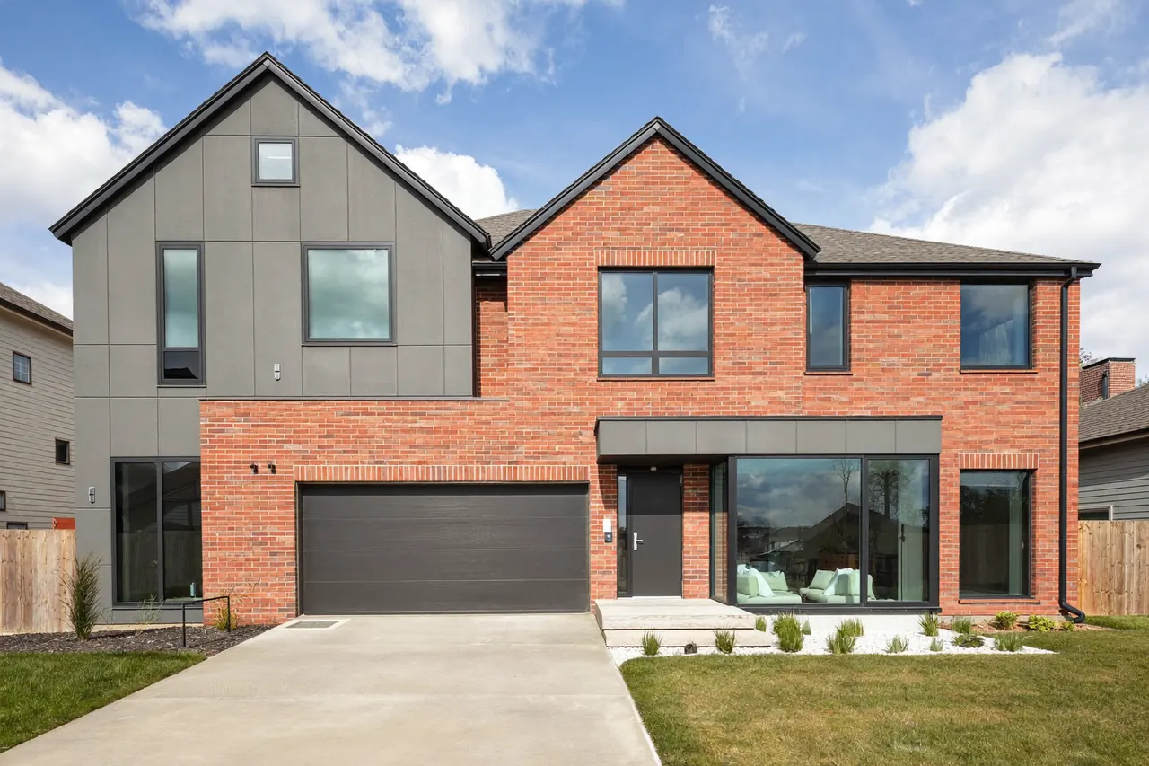 Matching anthracite-grey windows and front door on a modern red-brick semi-detached home