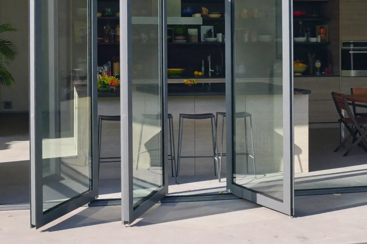 Close-up of the bottom track and rollers on an aluminium bifold door threshold