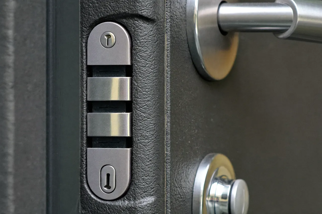 Detail of a multi-point lock and chrome handle on an anthracite composite front door