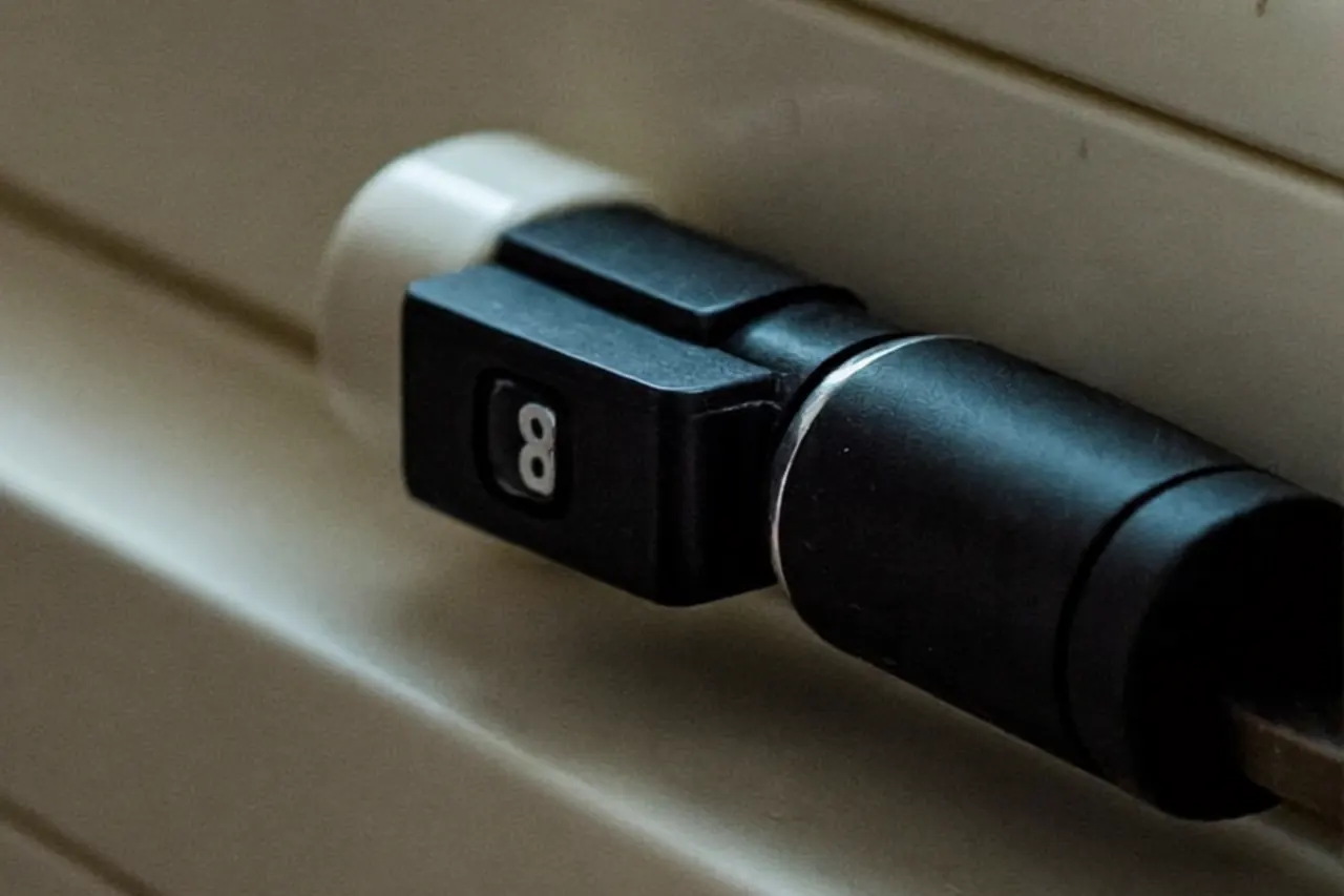 Close-up of a brushed-steel window handle matching the front door hardware on a white frame